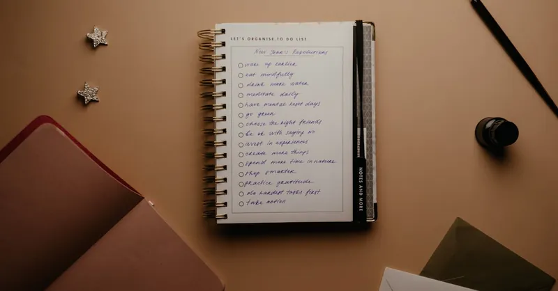 Flat lay of a notebook planner with a handwritten to-do list for effective organization.