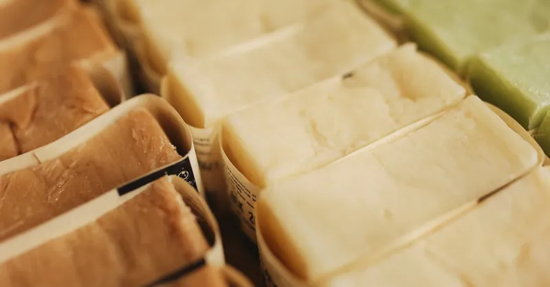 A variety of handmade natural bar soaps displayed in an organized manner, perfect for skincare and eco-friendly beauty products.
