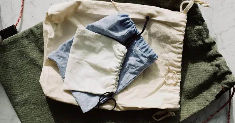 Eco-friendly fabric pouches neatly arranged on a marble surface for sustainable living.