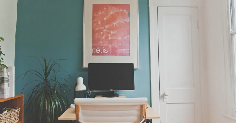 Contemporary home office setup with desk, chair, and decor elements in a minimalist design.