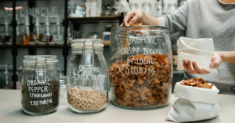 Person shopping at a zero waste store with organic products in reusable containers. Eco-friendly lifestyle.