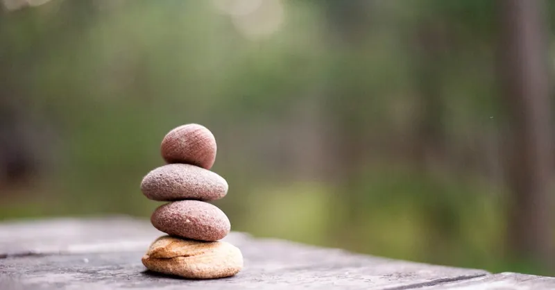 Balance and tranquility embodied by stacked stones in a natural outdoor setting.