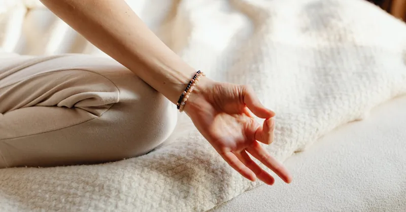 Serene image of a woman practicing meditation on a bed, embracing tranquility and relaxation.