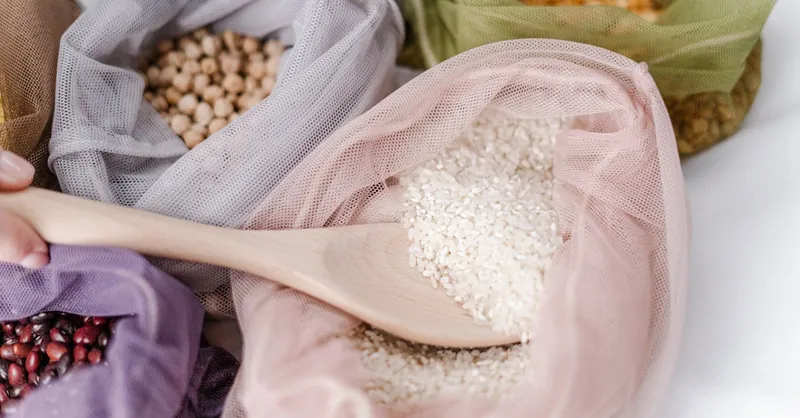 Close-up of eco-friendly reusable bags filled with various grains, promoting zero waste lifestyle.