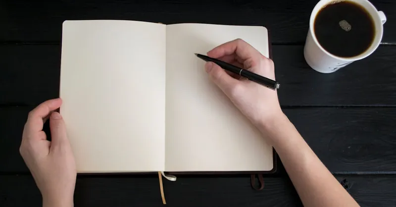 Empty notebook with a pen and coffee cup, perfect for writing inspiration concepts.