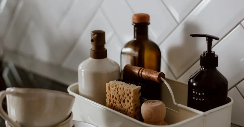 Close-up of chic kitchen cleaning essentials on a stylish countertop.