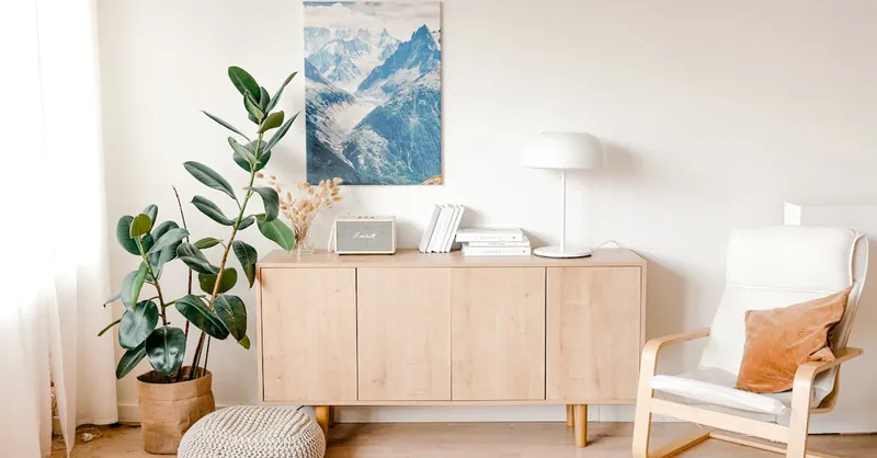 A calming minimalist living room with a wooden cabinet and stylish decor elements.