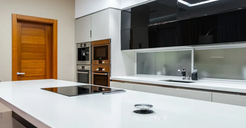 Interior of modern spacious kitchen area with minimalistic style placed in contemporary apartment