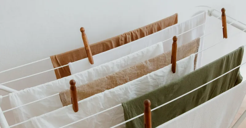 A minimalist image of clothes drying on a rack indoors, showcasing neatness and order.