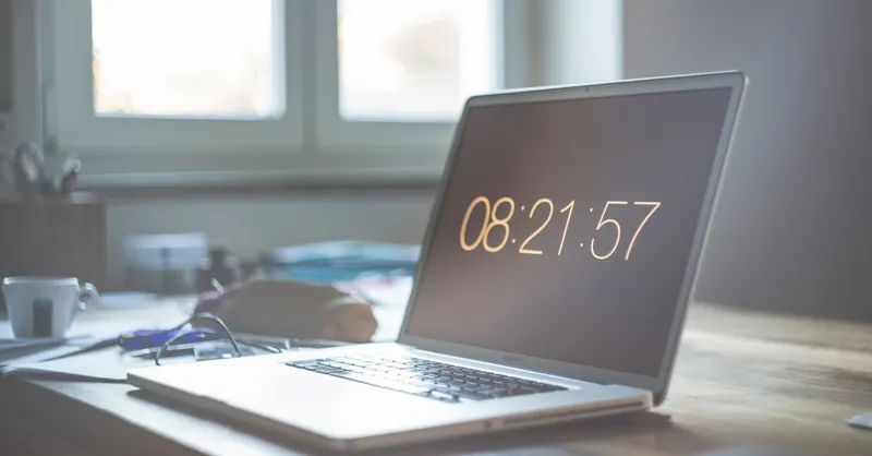 A serene workspace featuring a laptop with digital time display, perfect for productivity and focus.