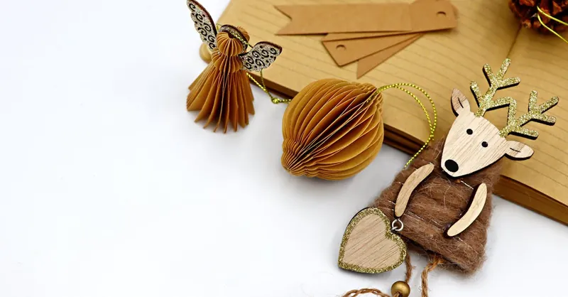 Stylish recycled paper and wood Christmas decorations for an eco-friendly holiday season.